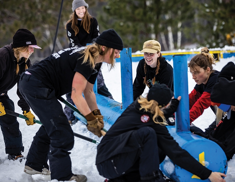 The all-female build crew, including author Marsha Hovey (third from right), at Take the Rake—a women’s terrain park meet-up at Trollhaugen, Wis., in 2021.